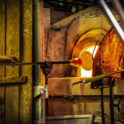 SevenTiger002 Glassblowing artisan at work in a crystal glass workshop in Murano island Venice Lagoon.Murano glassmakers use the same tools as their ancestors have thousands of years ago.